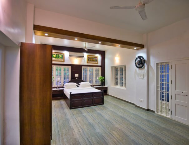 Scenic view of the bedroom in a Pool Villa at Softouch Ayurveda Village Kerala, overlooking the pool and lush surroundings.