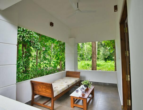 Private balcony of a Grand Cottage at Softouch Ayurveda Village, Kerala, providing a serene and intimate outdoor space amidst lush surroundings, perfect for relaxation and tranquility