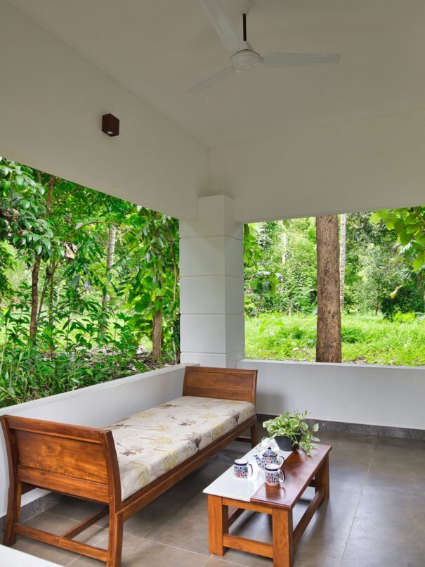 Private balcony of a Grand Cottage at Softouch Ayurveda Village, Kerala, providing a serene and intimate outdoor space amidst lush surroundings, perfect for relaxation and tranquility